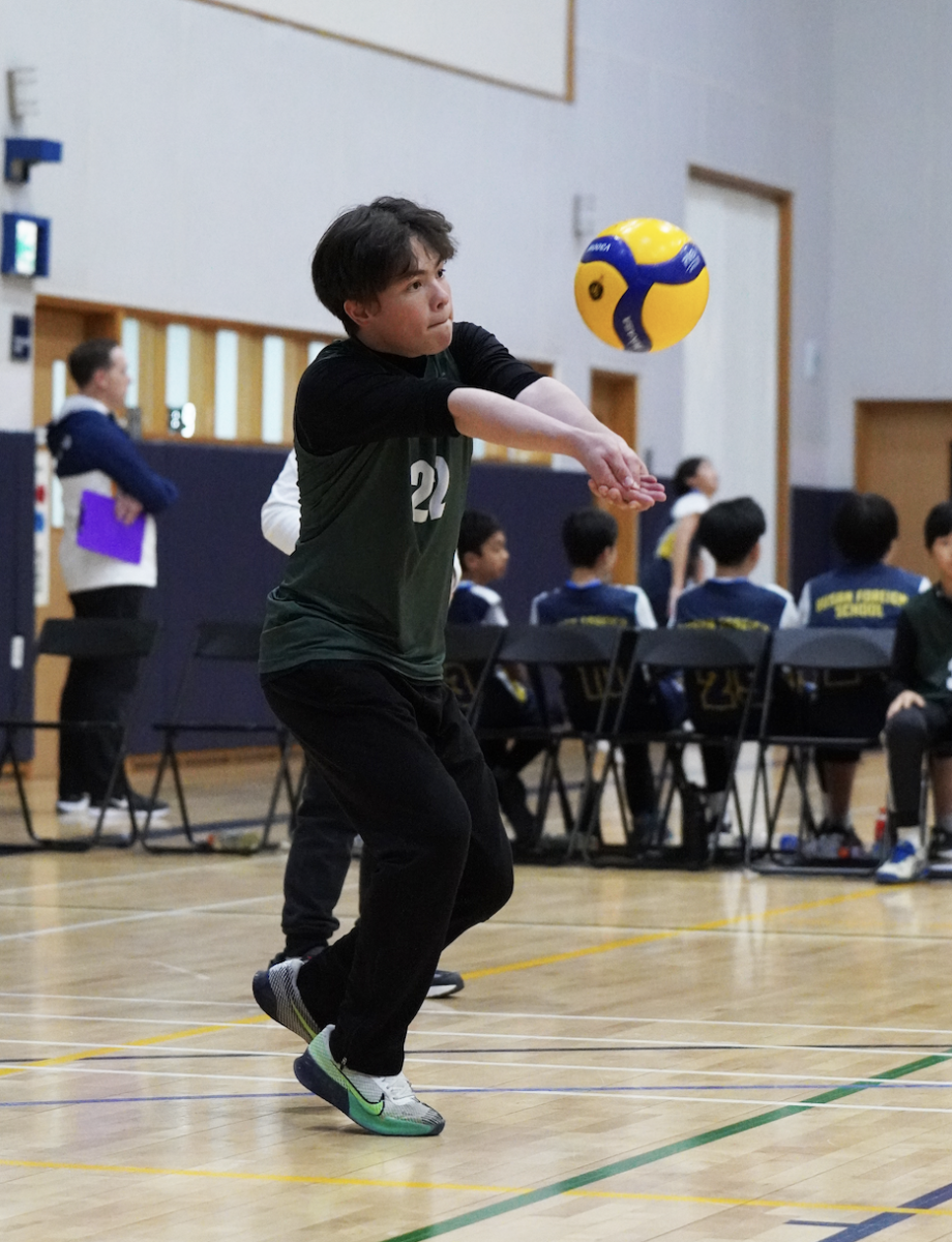Sahn Choi lowers into his defensive stance and passes perfectly to the setter. The pass boosts the back row with confidence.